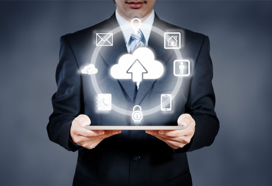 Business man holding a tablet with several icons floating above it in a circular pattern