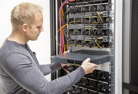 Man installing a server in a rack system